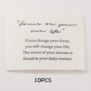 TEMU DIY 재봉틀용 영감을 주는 문구가 있는 천 라벨 10팩 - 코르크 배경 디자인의 흰색 패브릭 태그