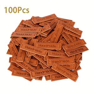 TEMU 구멍이 있는 인조 가죽 태그 100개입 - 코바늘 뜨개질 용품, 주얼리 및 뜨개질 용품을 위한 수제 공예 라벨에 적합합니다. 'HANDMADE' 단어와 사전 펀칭 구멍이 있는 내구성이 뛰어난 갈색 인조 가죽 태그는 공예에 이상적입니다.