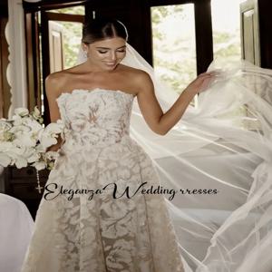 멋진 레이스 아플리케와 꽃무늬 A라인 실루엣 신부 드레스가 특징인 맞춤형 끈 없는 웨딩 드레스 Vestidos De Novia